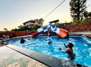 Happy Customers enjoying the double waterslides swimming pool at Sabo Resort Panchgani